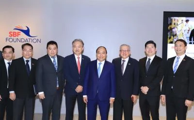 政府总理阮春福与新加坡一流企业集团领导代表合影。（图片来源：越通社）