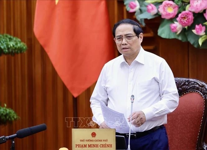 PM Pham Minh Chinh speaks at the meeting between permanent Government members and representatives of ministries and sectors on August 16. (Photo: VNA)