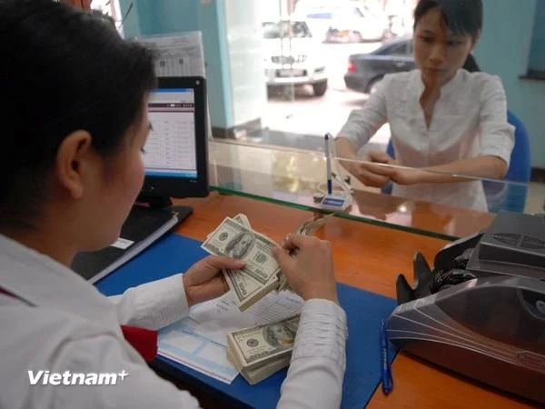 La diminution des taux d'intérêt par la Fed atténuerait la pression sur le taux de change USD/VND. Photo: Vietnamplus