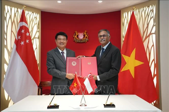 Lors de la signature du traité d'entraide judiciaire en matière pénale entre le Vietnam et Singapour. Photo: VNA