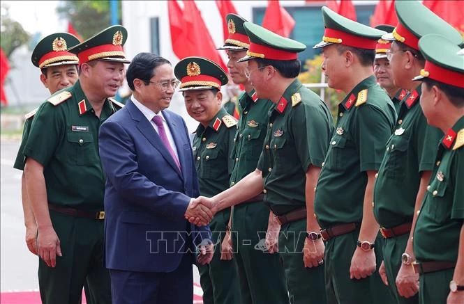 El primer ministro Pham Minh Chinh y las autoridades de la Corporación de Construcción Truong Son. (Fuente:VNA)