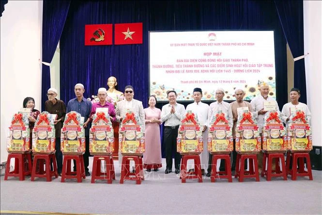 Pham Minh Tuan, vice-président du Comité municipal du FPV (centre) remet des cadeaux aux représentants des Conseils de gestion des mosquées et des oratoires à l'occasion de la fête Raya Idil Adha. Photo: VNA