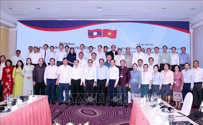 HCM City and Lao participants of the meeting pose for a group photo (Source: VNA)