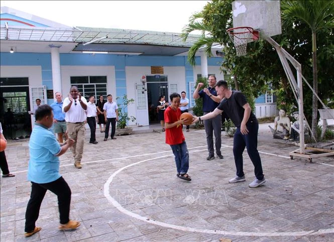 A basketball match with the children cared at the centre takes place as part of the visit. (Photo: VNA)