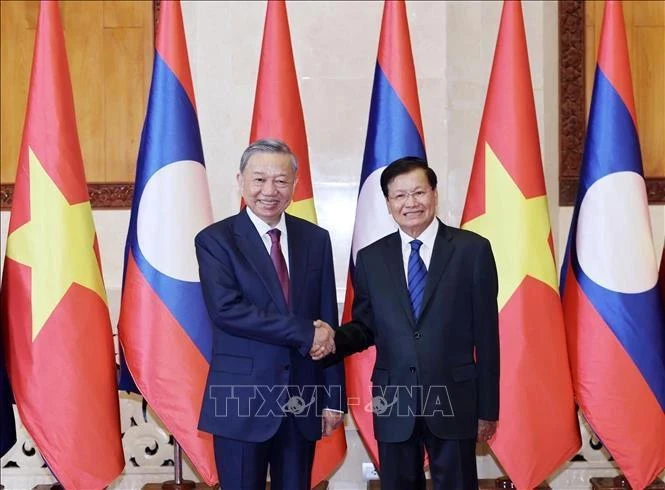 El presidente To Lam (izq.), el secretario general del Partido Popular Revolucionario (PPRL) y presidente de Laos, Thongloun Sisoulith, sostienen conversaciones en Vientiane el 11 de julio (Foto: VNA)