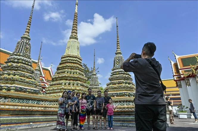 Tourists take photos at Wat Pho Temple in Bangkok. (Photo: AFP/VNA)