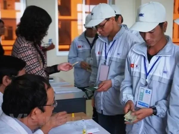 Workers complete procedures to go abroad. (Photo: VNA)