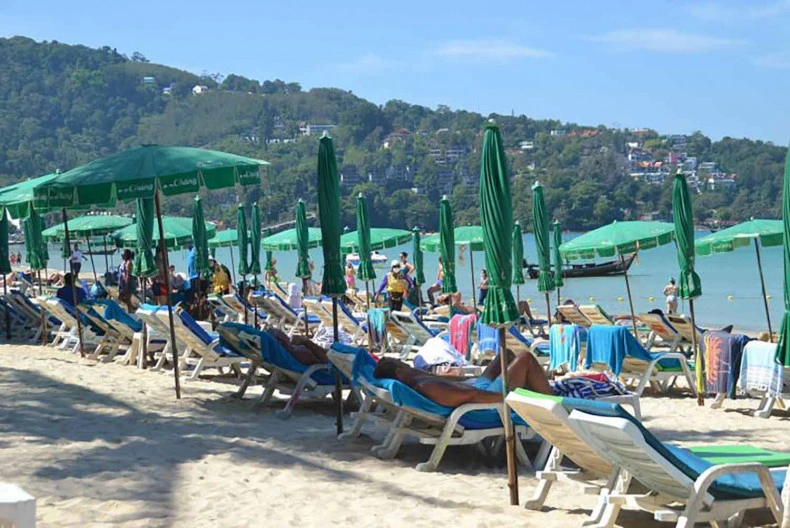 Tourists relax on a beach in Phuket (Photo