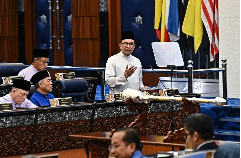 Malaysian Prime Minister Anwar Ibrahim unveiling the 2025 national budget at the Malaysian Parliament in Kuala Lumpur on Oct 18. (Photo: AFP)