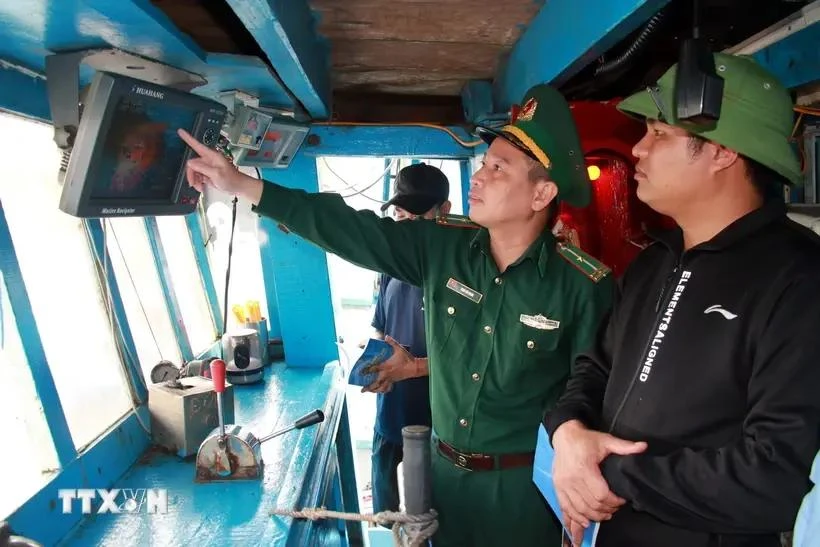 A representative from authority inspects the installation of vessel monitoring system (VMS) in a fishing vessel. (Photo: VNA)