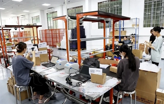 Workers from a cosmetics store based in Thu Duc city pack products for online shoppers. (Photo: VNA)