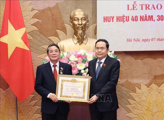 越南国会主席陈青敏向越共中央委员、国会党组委员、国会副主席阮德海同志授予40年党龄纪念章。图自越通社