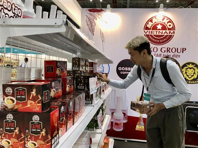 A consumer visit a booth at the Vietnam International Cafe' Show 2024. (Photo: VNA)