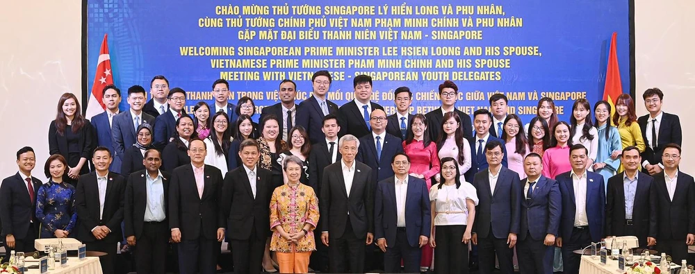 Prime Minister Pham Minh Chinh (seventh from right) and then Singaporean Prime Minister Lee Hsien Loong (eighth from right), officials, and youth delegates at the Vietnam - Singapore youth leaders exchange programme 2023 in Hanoi on August 29. (Photo: VNA)