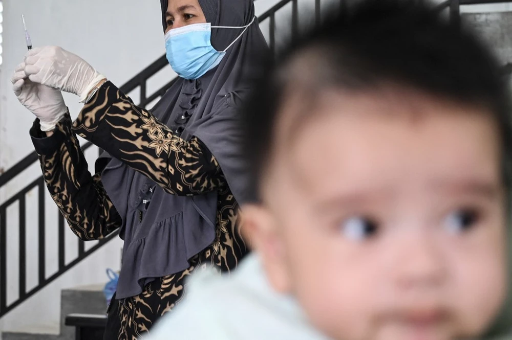 A nurse prepares a Bacillus Calmette-Guerin (BCG) vaccine for tuberculosis during a national immunisation for children programme at an integrated services post in Banda Aceh, Aceh on June 9, 2022. (Photo: AFP)