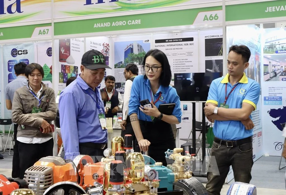 People are at a display booth at the Agri Vietnam 2024. (Photo: VNA)