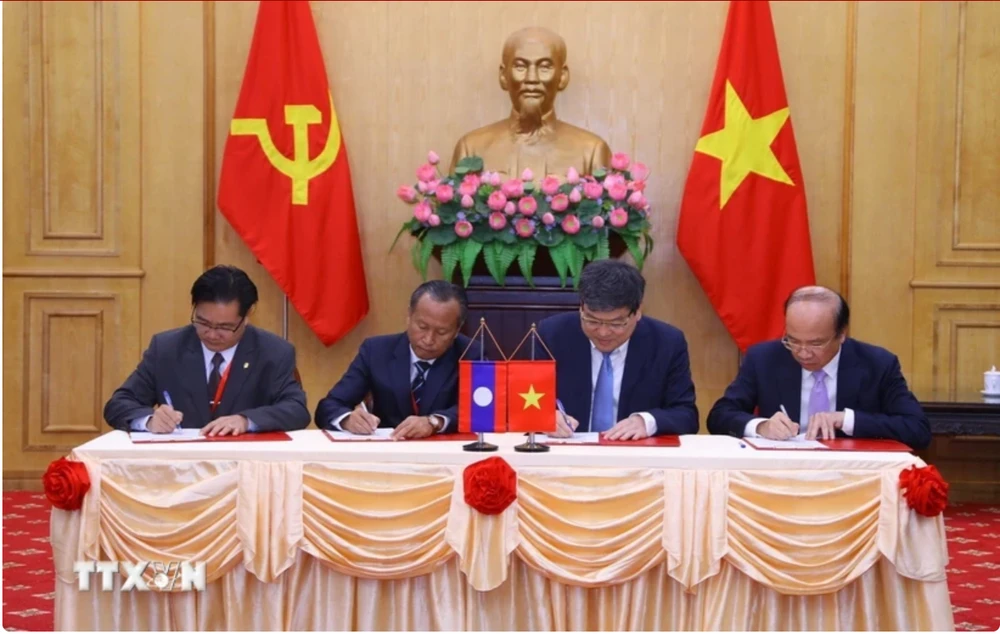 Representatives from the Ho Chi Minh National Academy of Politics, the Vietnam Academy of Social Sciences, the Lao National Academy of Politics and Public Administration, and the Lao National Institute of Economic and Social Sciences sign cooperation agreements on June 30, 2023. (Photo: VNA)