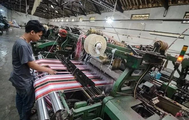 A worker completes production of sarong cloth in a textile factory in Majalaya industrial estate in Bandung regency, West Java. (Photo: Antara) 