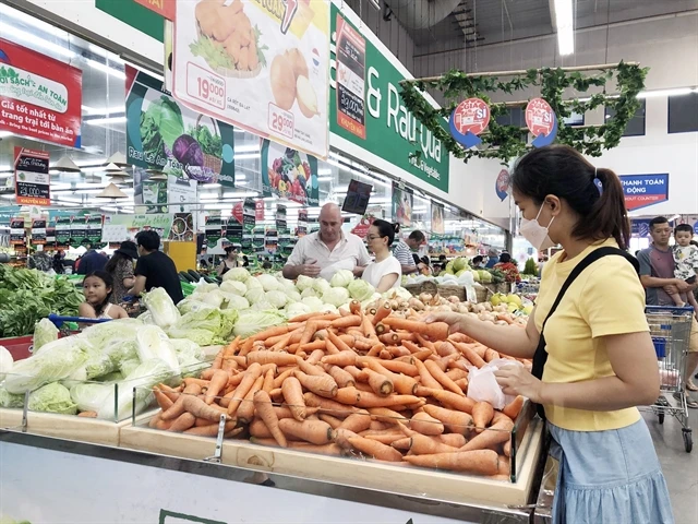 Customers shop at a supermarket in HCM City. (Photo: VNA)