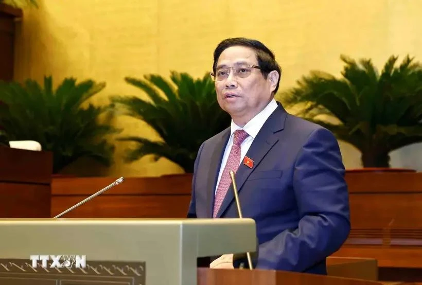 Prime Minister Pham Minh Chinh delivers a report at the ongoing 8th session of the 15th National Assembly in Hanoi on October 21. (Photo: VNA)