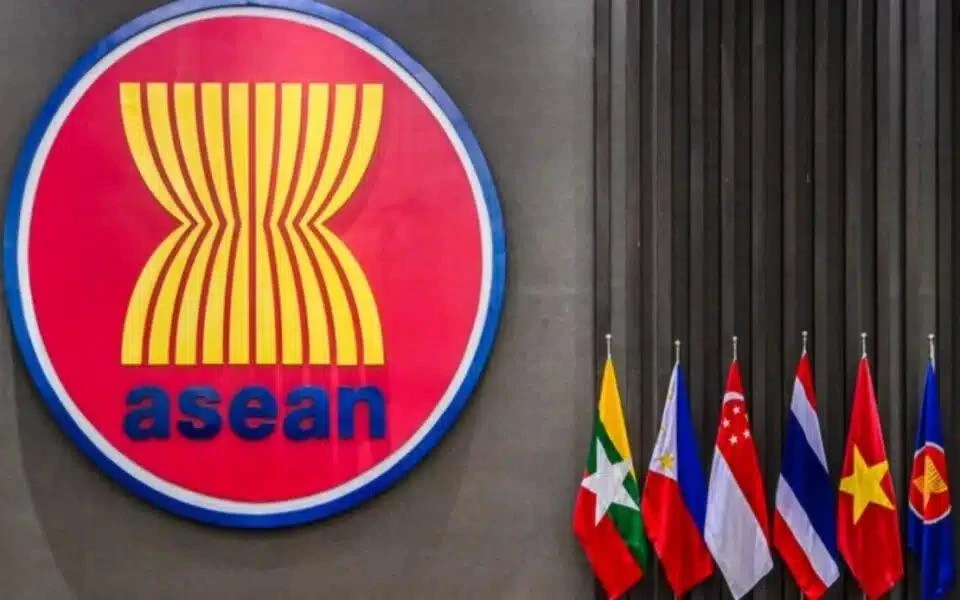 The ASEAN logo seen outside a building next to the flags of some of its members, in this file photo. — (Photo: BERNAMA)