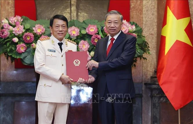 El secretario general del Partido Comunista y presidente de Vietnam, To Lam, entrega la decisión de promoción al rango de general a Luong Tam Quang, ministro de Seguridad Pública (Fuente: VNA)