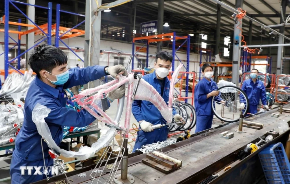 Workers assemble bicycles at the Thong Nhat Hanoi Joint Stock Company (Photo: VNA)