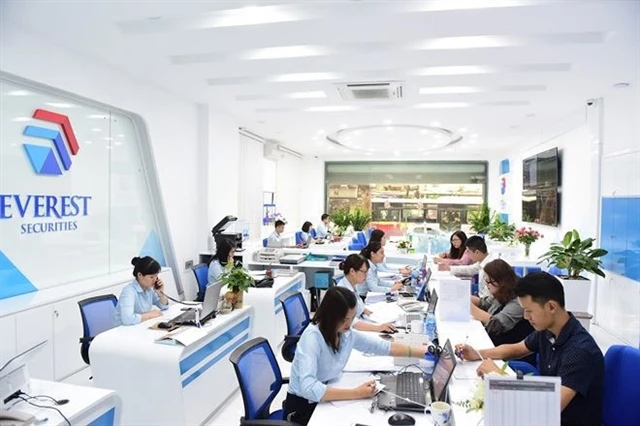 Traders work at a trading floor of Everest Securities. The securities company's profit dipped 88 per cent in the first nine months of 2024. (Photo courtesy of EVS)