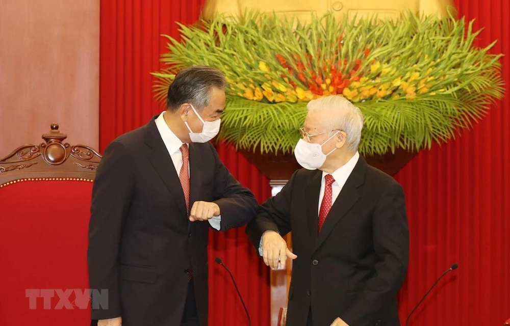 Party General Secretary Nguyen Phu Trong (R) greets Wang Yi, State Councilor and Foreign Minister of China (Photo; VNA)