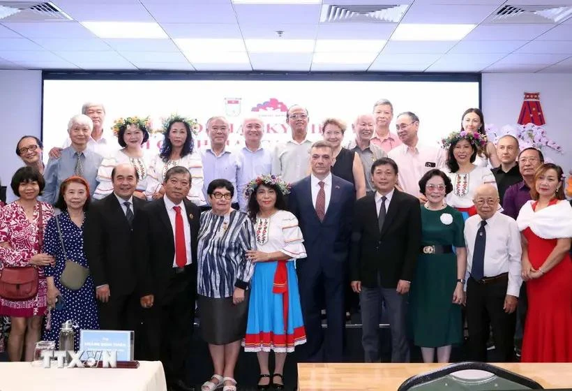 Participants pose for a group photo at the get-together in HCM City on November 5. (Photo: VNA)